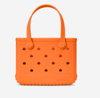 Bogg Bag Bitty orange rubber tote with pumpkin cutouts and loop handles