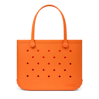 Bogg Bag Original tote in orange with red pumpkin pattern holes and loop handles