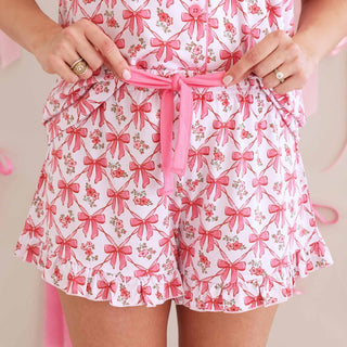 Ruffled hem and pink drawstring tie detail on women's pajama shorts