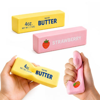 Yellow salted butter and pink strawberry squishy being squeezed by hand