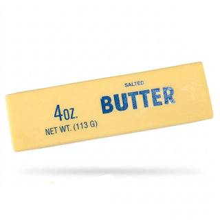 Single yellow salted butter stick shaped squishy toy on white background