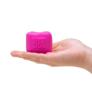 Hand holding a hot pink NeeDoh Color Change Cube stress relief sensory toy