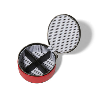 Brighton red round jewelry box open showing black cross dividers and polka dot interior