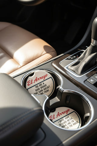 El Arroyo car coaster set featuring two round coasters with humorous driving-themed messages