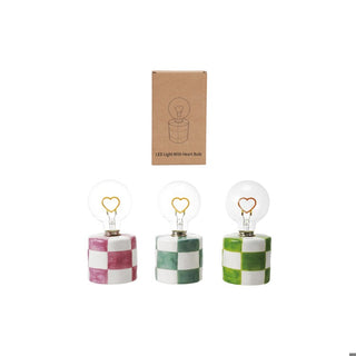 Three decorative light bulbs with checkered bases, accompanied by a cardboard box.