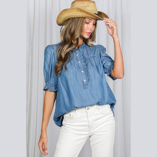 Chambray ruffle shirt three-quarter view showing high-low hem and gathered bust detail
