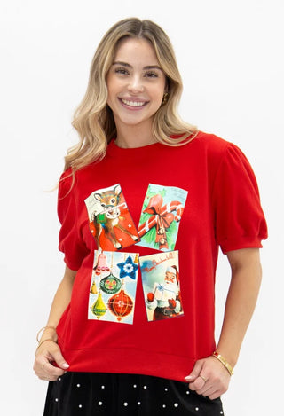 Red puff sleeve top with vintage Christmas card collage graphic print