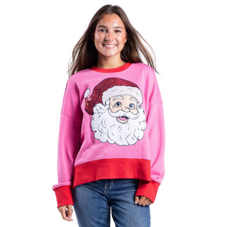 Young woman wearing pink Santa Claus sequin graphic crew neck Christmas sweatshirt with red trim