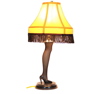 A Christmas Story 40-inch leg lamp with fishnet stocking, high heel, and fringed yellow shade