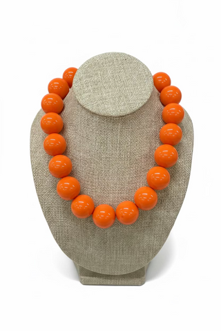 The Blessed Nest chunky orange glossy large round bead necklace on display bust