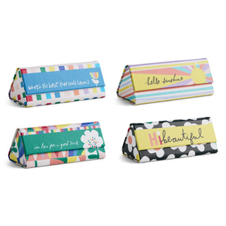 Set of four colorful collapsible sunglass cases with uplifting printed phrases and patterns