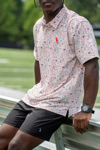 Male model wearing Local Boy Outfitters Dirty Myrtle Collegiate Game Day polo in red and black print
