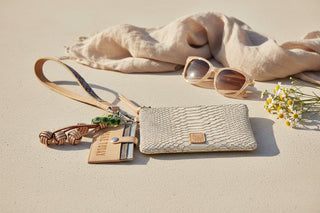 Beige wristlet with snake skin pattern, colorful strap, and keychain