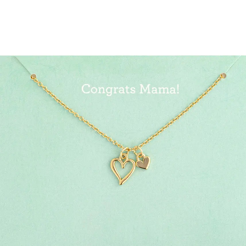 Gold necklace with heart charms on a light green background