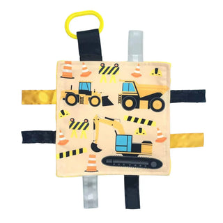 Square beige baby lovey featuring yellow bulldozer print and textured ribbons flat lay
