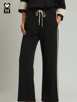 Black wide-leg drawstring pants with cream side stripe and side pockets