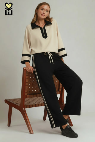 Black wide-leg pants with cream side stripes and drawstring waist