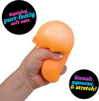 Hand squeezing orange squishy stress ball cat toy, deforming under pressure