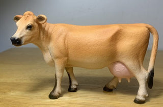 Model of a cow on a wooden surface 