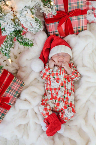 Sleeping newborn in Caden Lane Cozy Claus Santa plaid Christmas zipper footie with matching hat