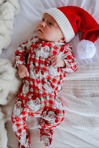 Baby wearing Caden Lane red plaid Santa print zipper footie with matching Santa hat