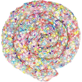 Translucent garden-themed thinking putty coiled in spiral revealing embedded pink yellow purple flowers and green leaves