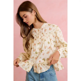 Cream long sleeve floral peplum blouse with ruffle cuffs and pink rose print