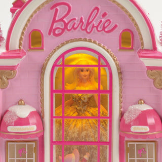 Pink Barbie themed decorative building with arched window displaying doll figure inside