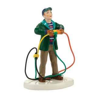 Department 56 ceramic figurine of man tangled in colorful Christmas light extension cords