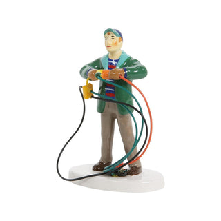 Department 56 ceramic figurine of a man tangled in colorful Christmas light extension cords