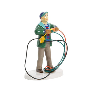 Department 56 figurine of dad holding tangled Christmas light extension cords outdoors