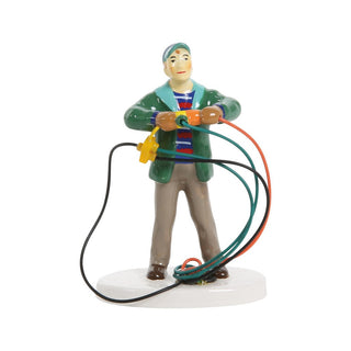 Department 56 figurine of dad tangled in colorful extension cords on snowy base