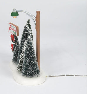 Department 56 lit Christmas tree lot display with miniature snow-covered trees and street lamp