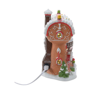 Back angle of Department 56 Piper's Piping Academy North Pole village house with ornamental scrollwork and power cord