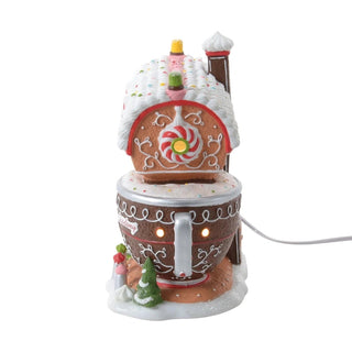 Close-up of Department 56 Piper's Piping Academy candy cane window and elf figure on lighted Christmas decor
