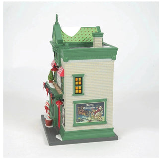 Rear view of Department 56 Santa's Corner Confectionery featuring vintage Santa sleigh illustration and chimney