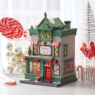 Department 56 Santa's Corner Confectionery Christmas village display on white tabletop with holiday decor