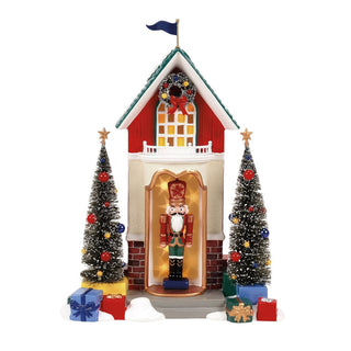Department 56 Snow Village Nutcracker Sentry building with Christmas trees and wrapped gifts