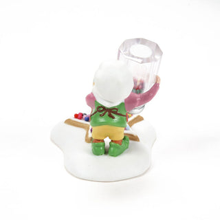 Department 56 elf figurine holding a candle holder with colorful sprinkles on a white base