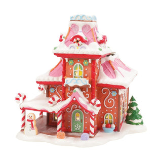 Department 56 Christmas village gingerbread-style house with snow and candy cane decorations