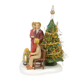 Department 56 figurine of family with Christmas tree on white base