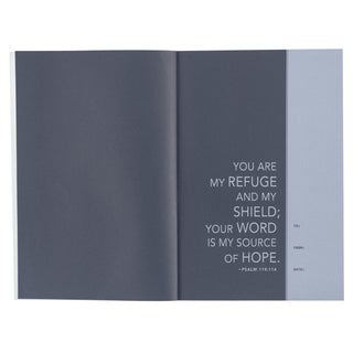 Interior spread of NLT Men's Devotional Bible showing Psalm 119:114 verse on dark blue pages