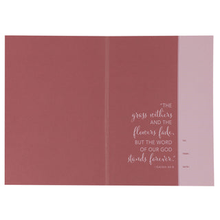 Interior spread of NLT Women's Devotional Bible showing Isaiah 40:8 scripture verse in rose tones