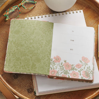 Open floral devotional journal with pink roses, green interior, and gift inscription page