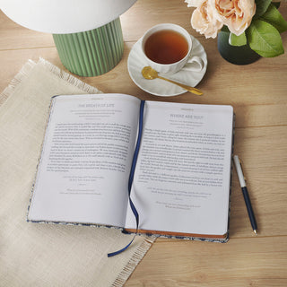 Open Simply Scripture devotional book showing January 5 and 6 entries on wooden desk with tea
