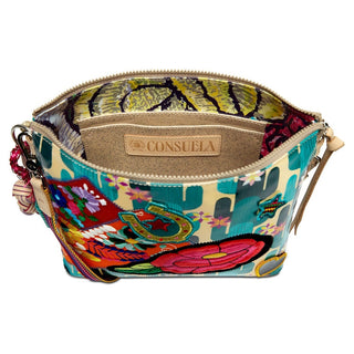 Interior view of Consuela Dezi crossbody featuring abstract yellow maroon lining and embossed brand label