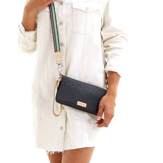 Consuela Diamond Uptown black glitter crossbody with striped strap and tan leather accents on white background