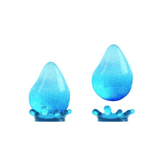 Two blue glittery Dream Drop Nee Doh stress balls shaped like water droplets with splash bases