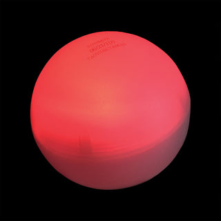 Glowing red Toysmith Eerie Ball on black background, smooth round toy