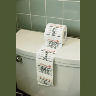 El Arroyo novelty toilet paper with fart jokes on white 3-ply rolls draped over bathroom toilet